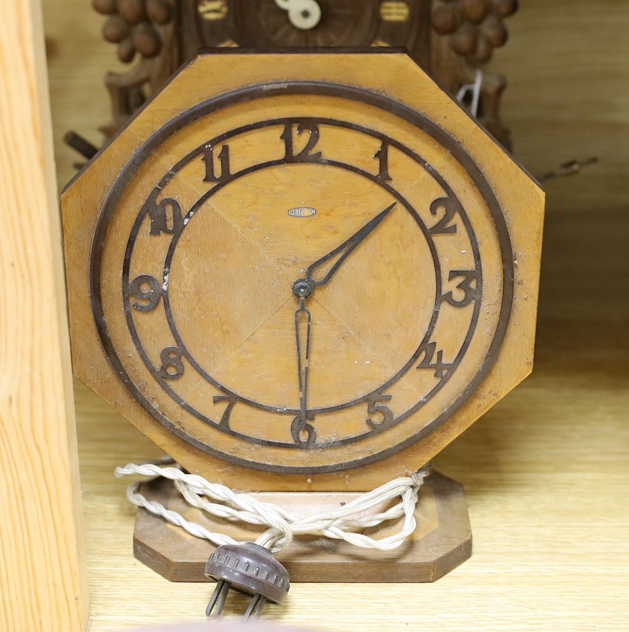 A Black Forest cuckoo clock, together with another octagonal faced timepiece, a Bakelite timepiece and another (4)